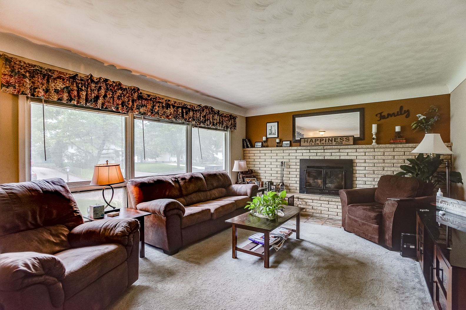 Cozy living room featuring replacement windows and neutral décor