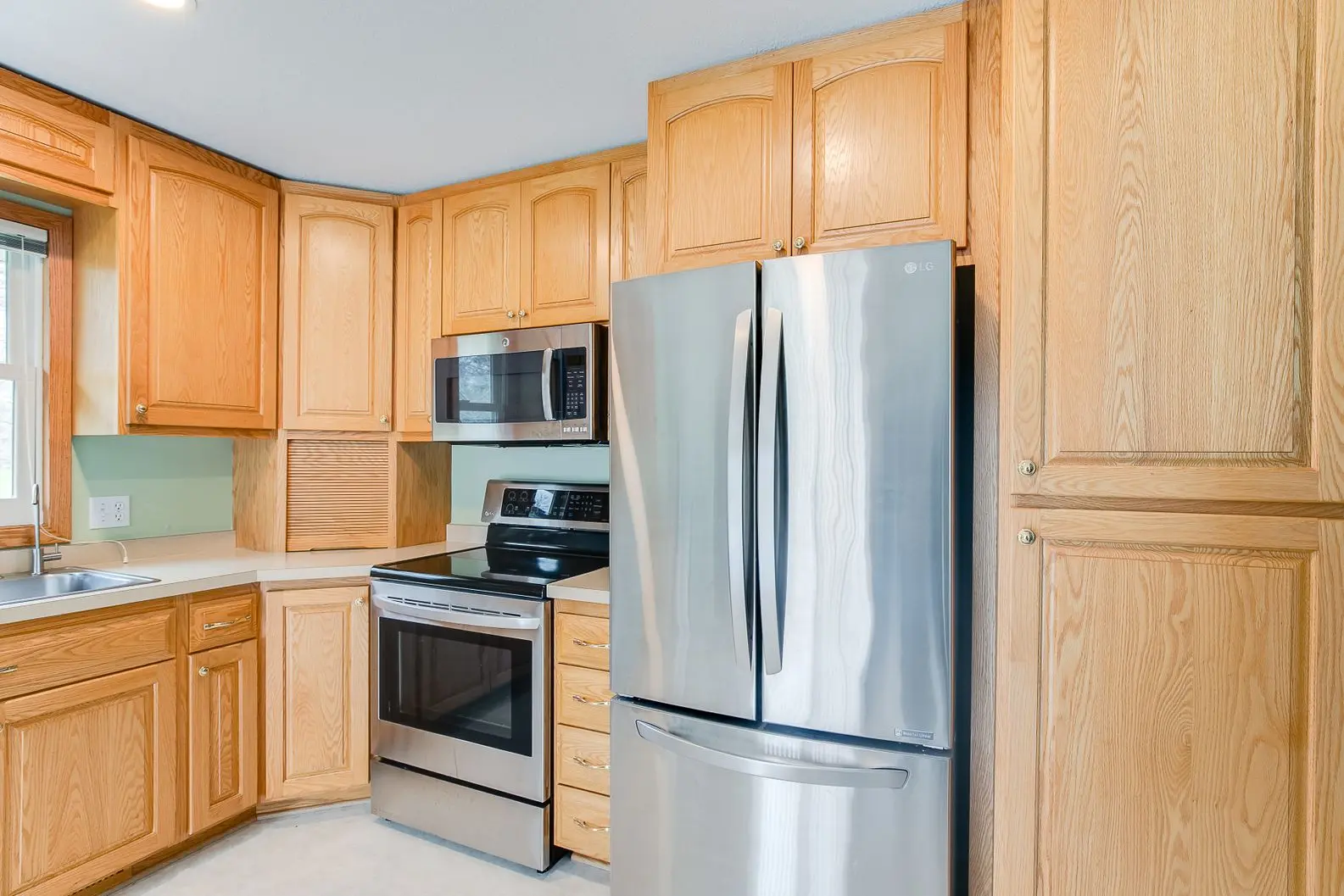 Home kitchen remodel with new refrigerator and wood cabinetry