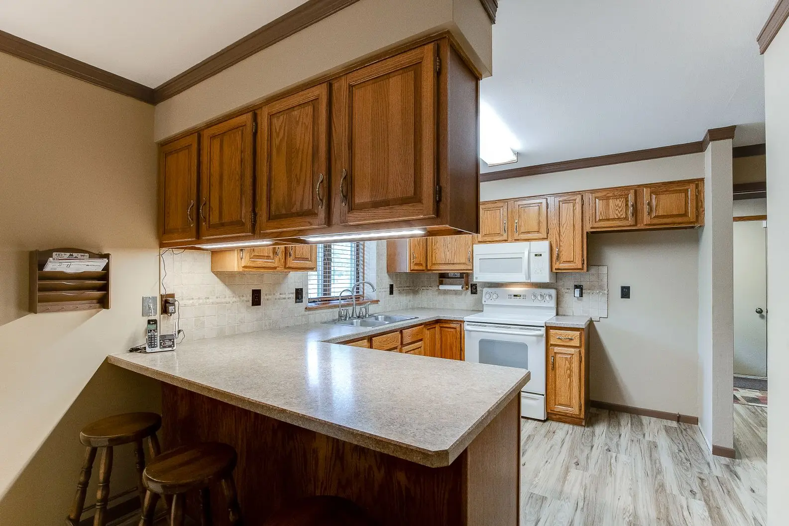 Kitchen renovation with oak cabinets, new countertops, and stainless appliances