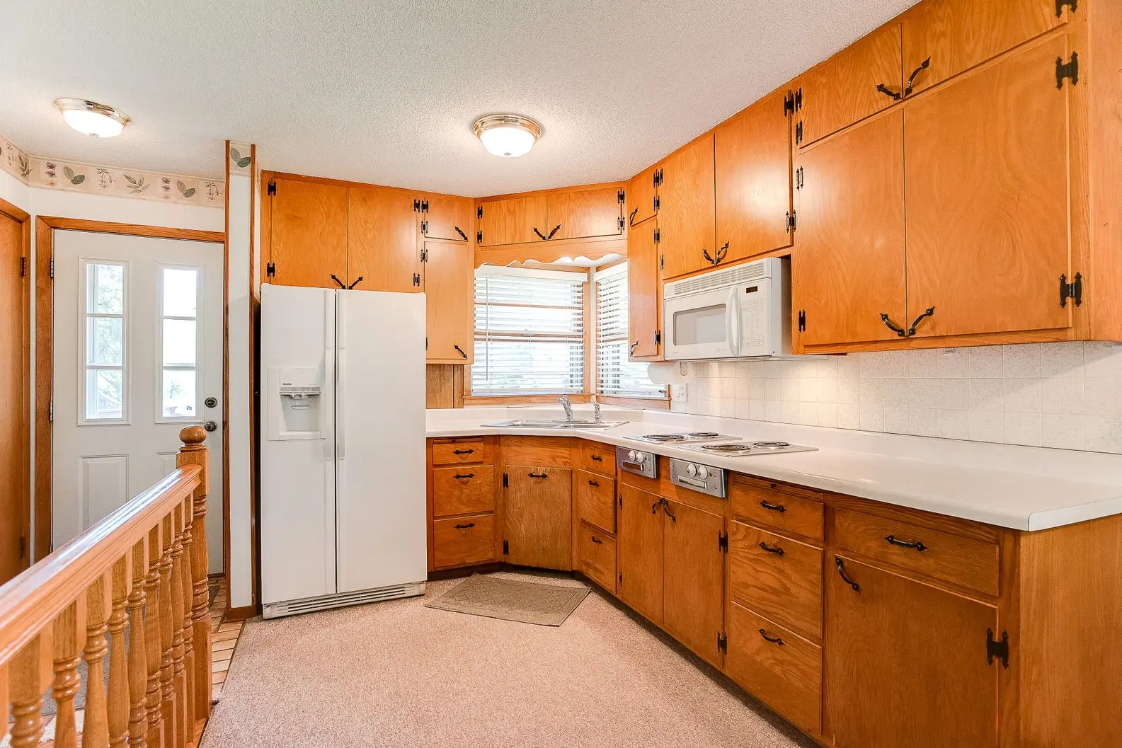 Classic kitchen with wood cabinets and white appliances