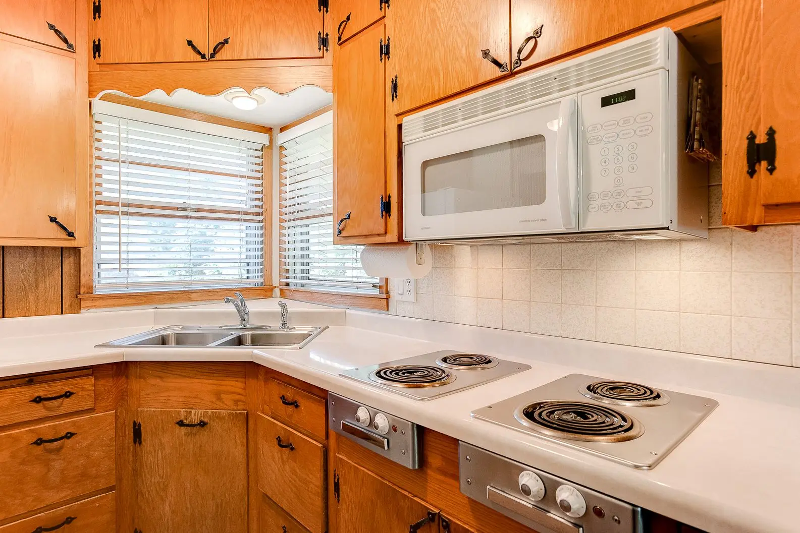 Small kitchen remodel with wood cabinets and white tile backsplash