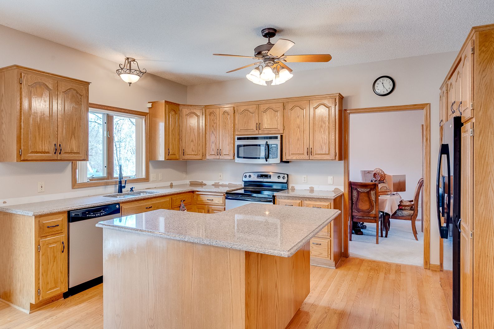 Open kitchen design with center island and pendant lights
