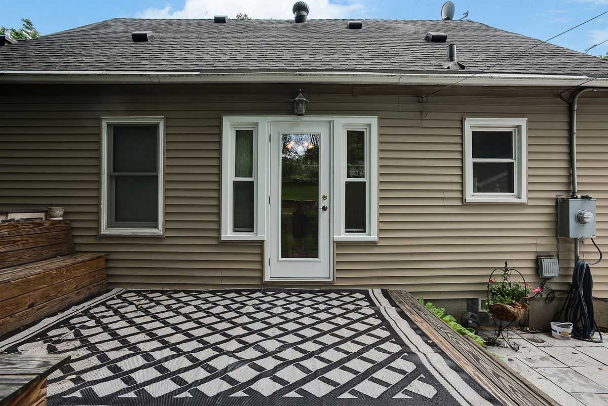 Backyard view showing new patio door and window installation