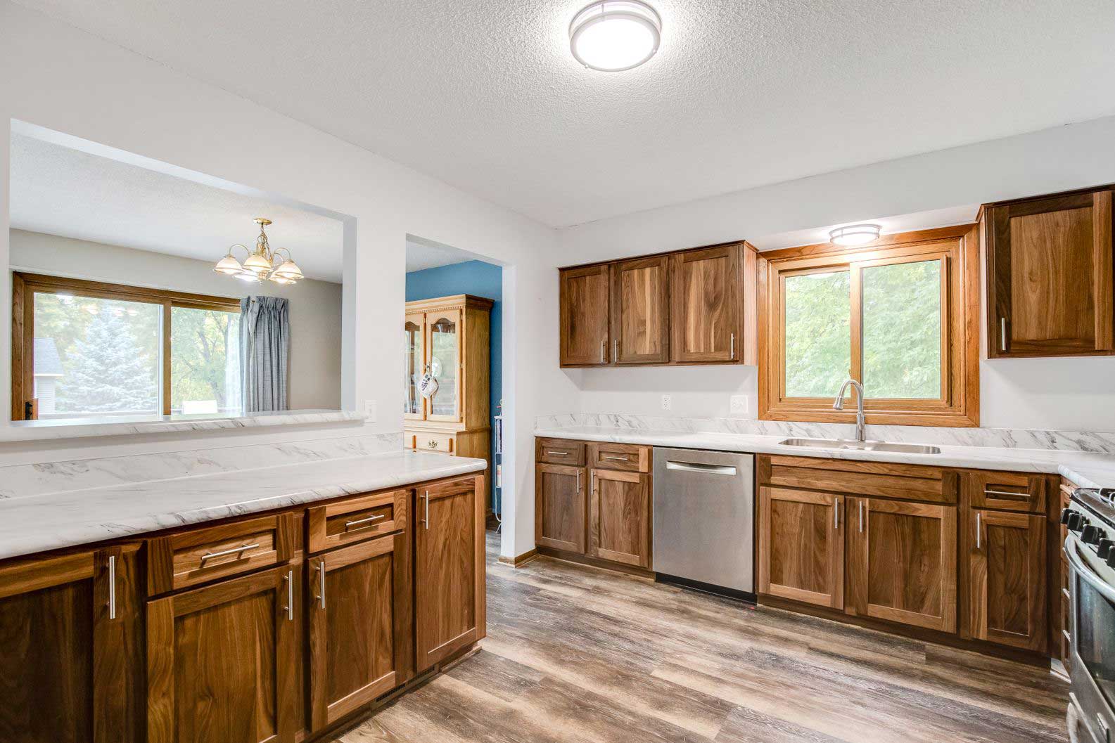 Kitchen remodel with oak cabinets, ceiling light, and new flooring