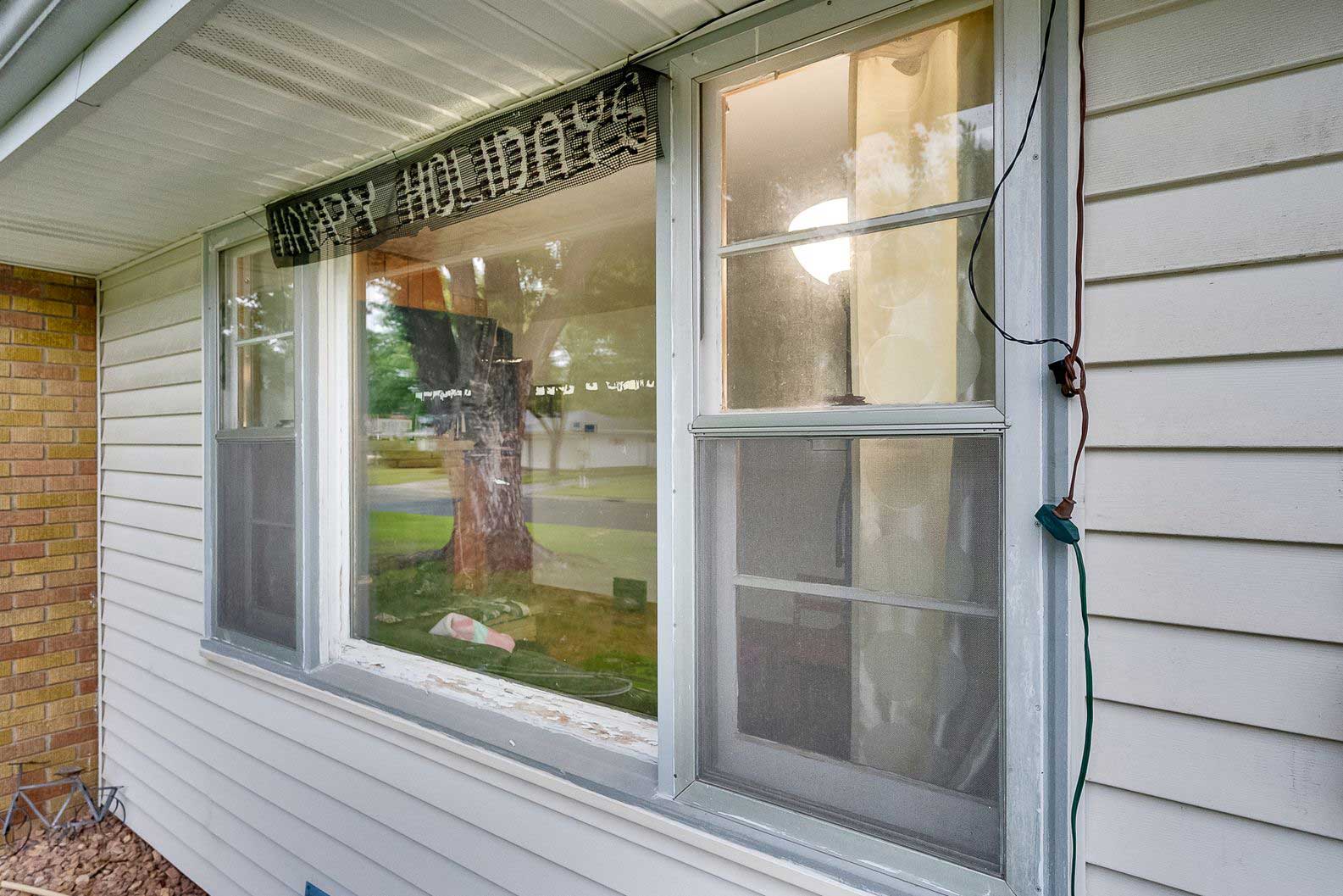 House exterior showing new window installation and trim update