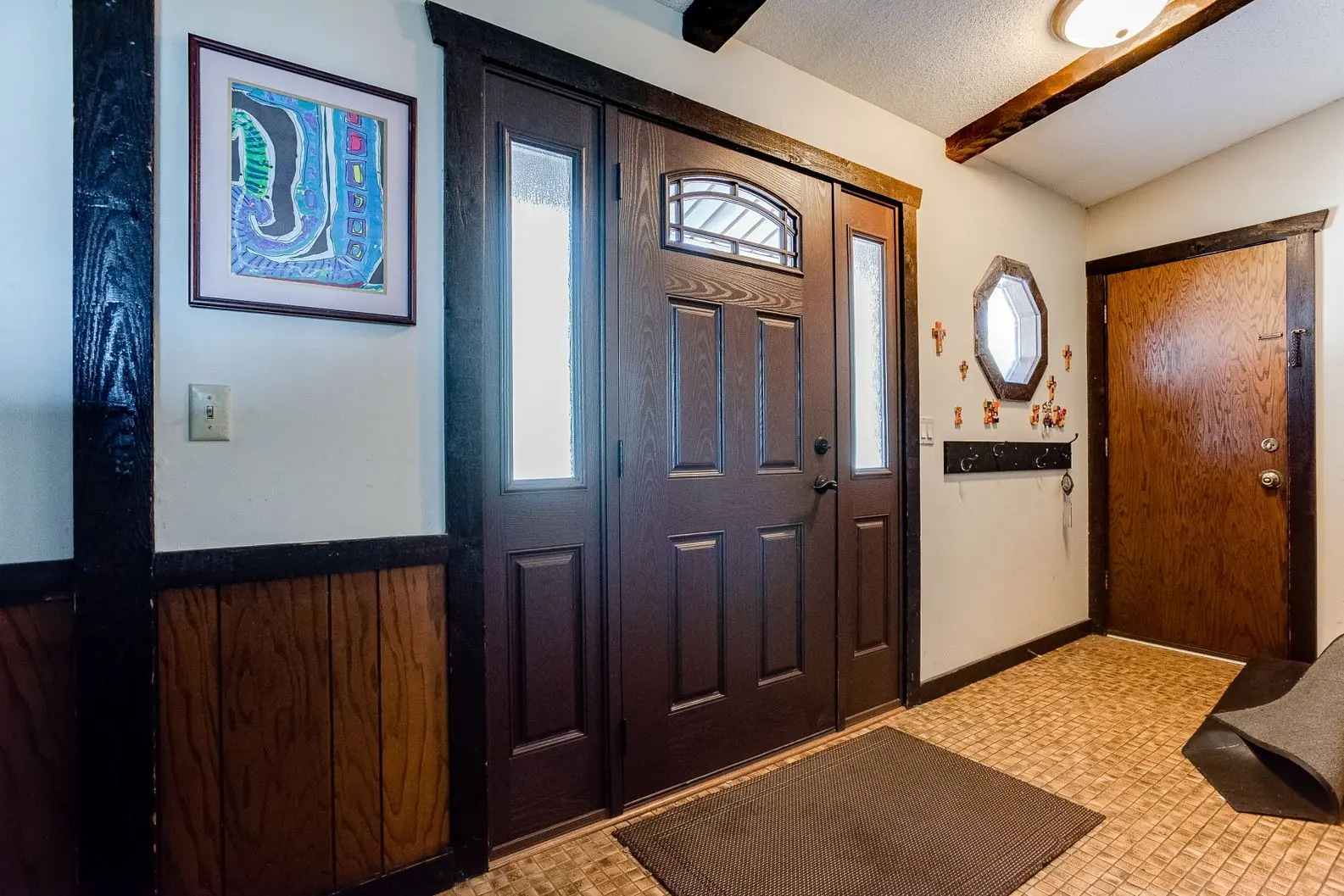 Dark brown front door replacement with arched window panel