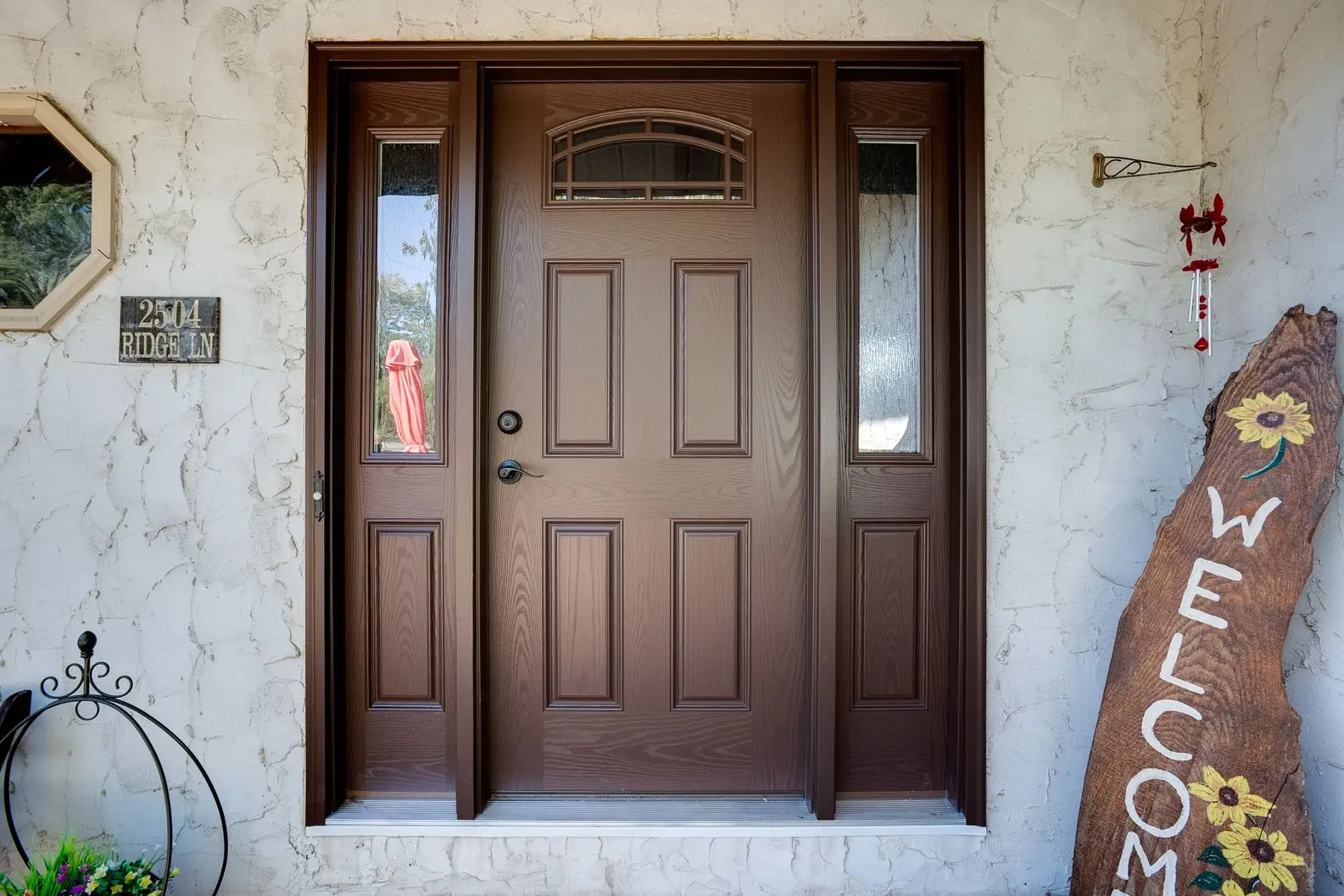 Dark brown front door replacement with arched window panel