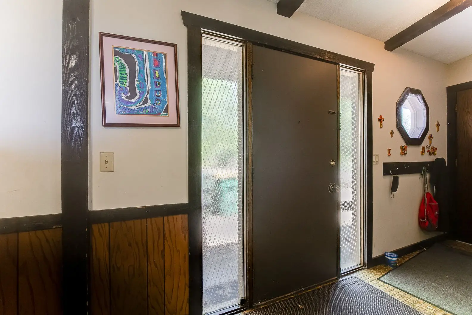 Black sliding barn door installed in remodeled home entryway
