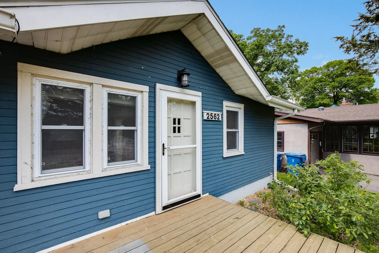 Updated exterior featuring blue siding and white-framed windows
