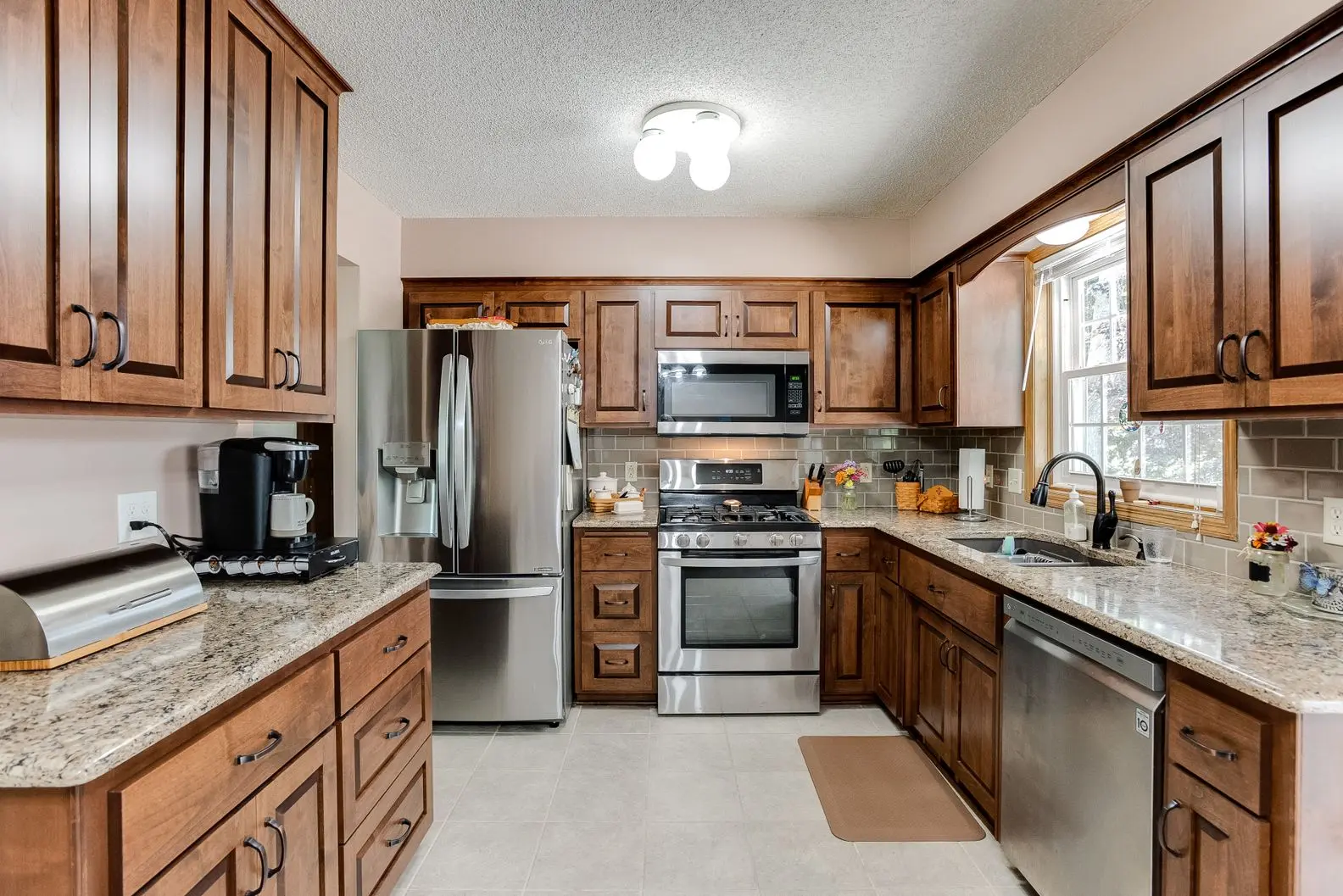 Modern kitchen renovation with stainless steel appliances and oak cabinetry