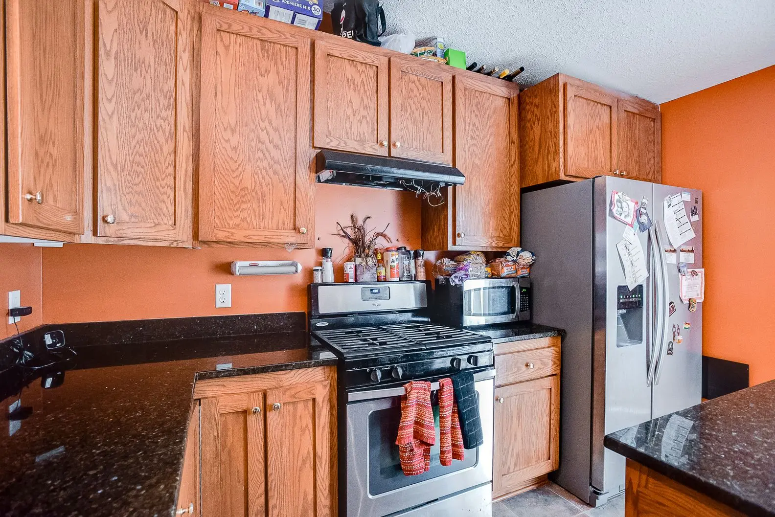 Kitchen remodel with modern wood cabinets, granite counters, and tile backsplash