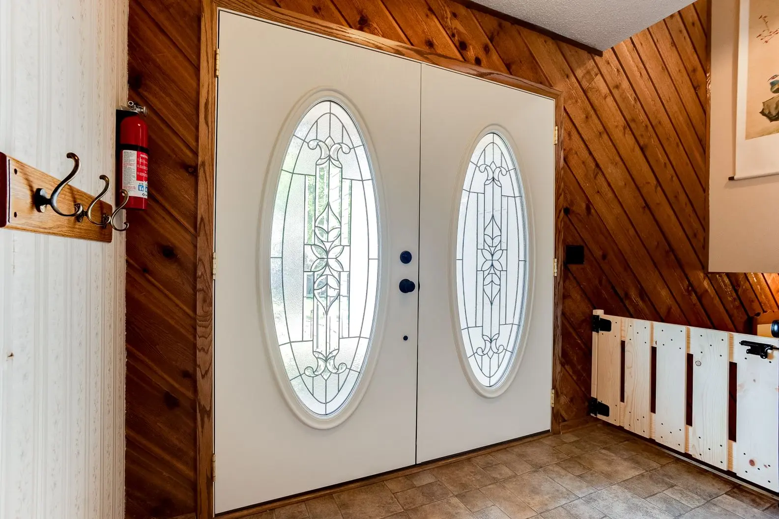 White entry door installation with oval glass windows