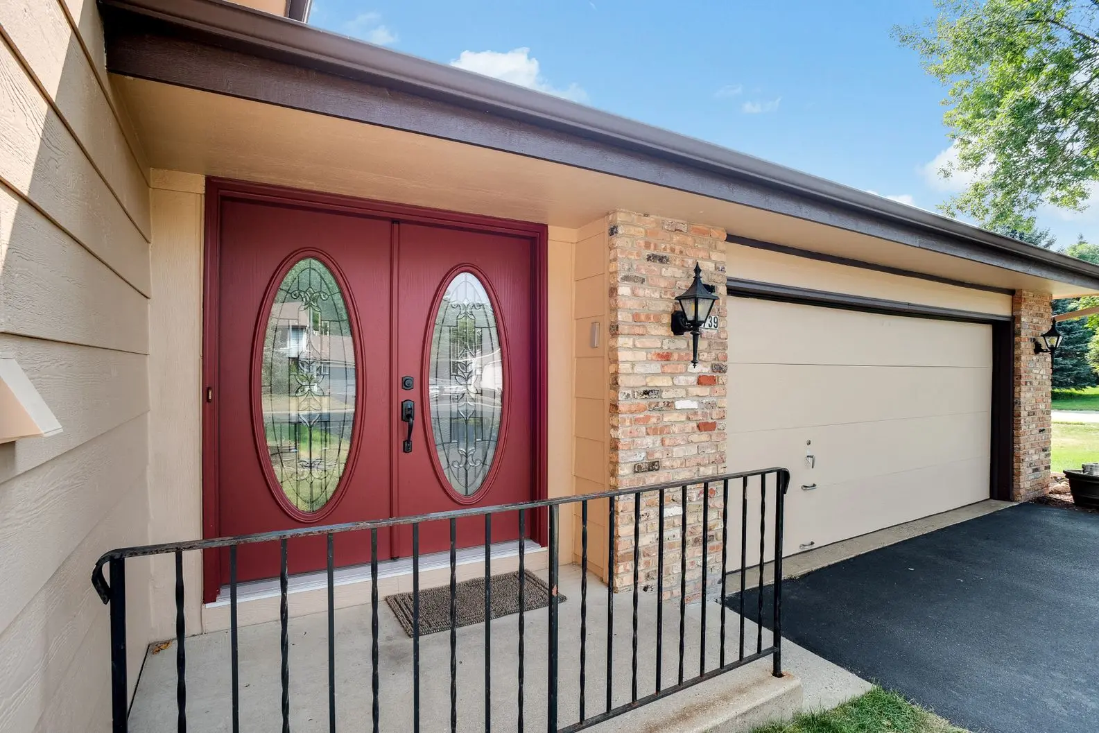 Red exterior door with oval glass panels on Minneapolis home