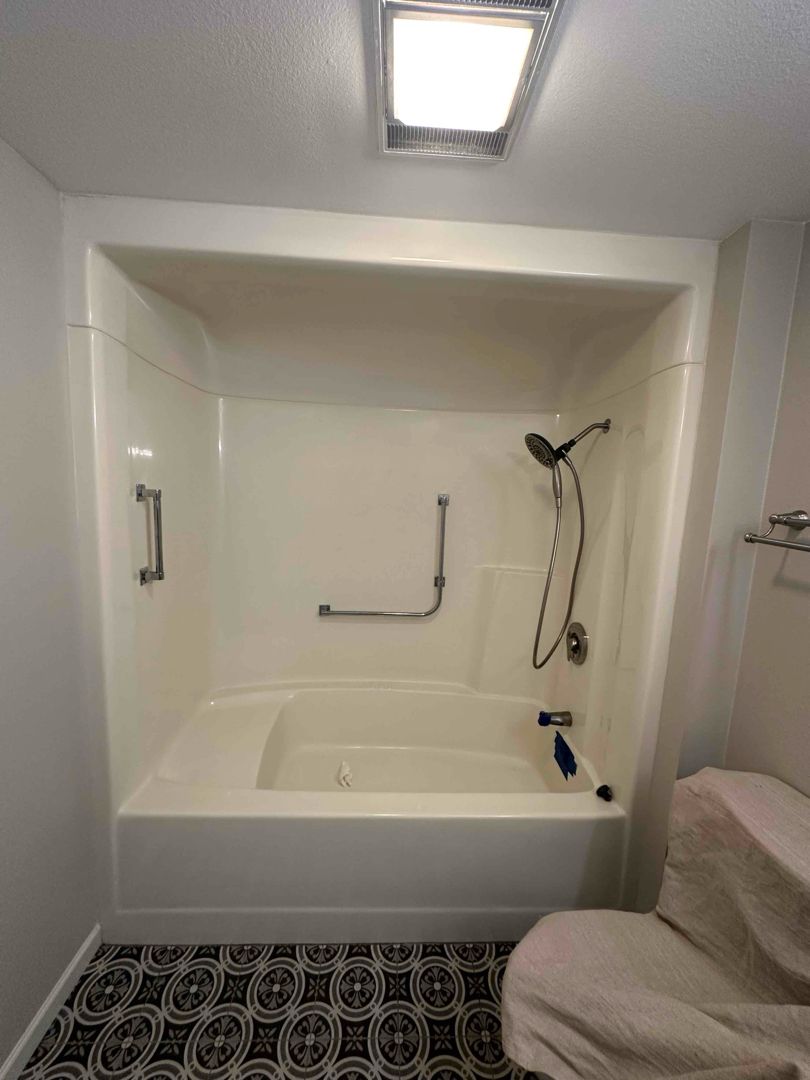 Small bathroom with new vinyl windows and white tile shower