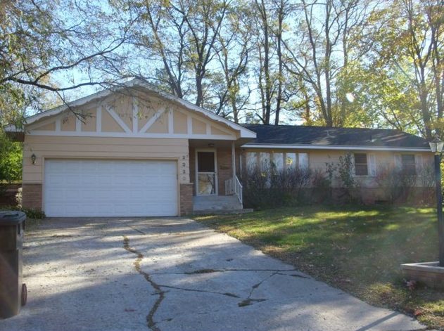 Suburban house featuring new garage door and window replacements
