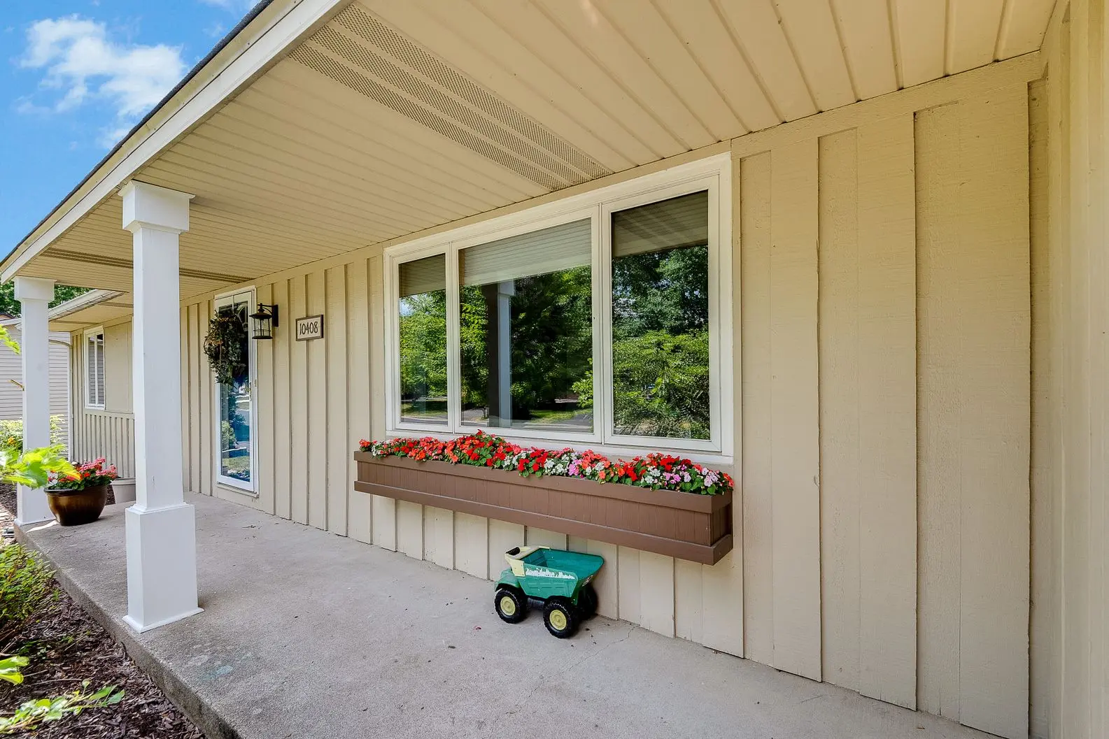 10408-Quebec-Ave-S-After-002 Home exterior with flower boxes and new triple-pane replacement windows