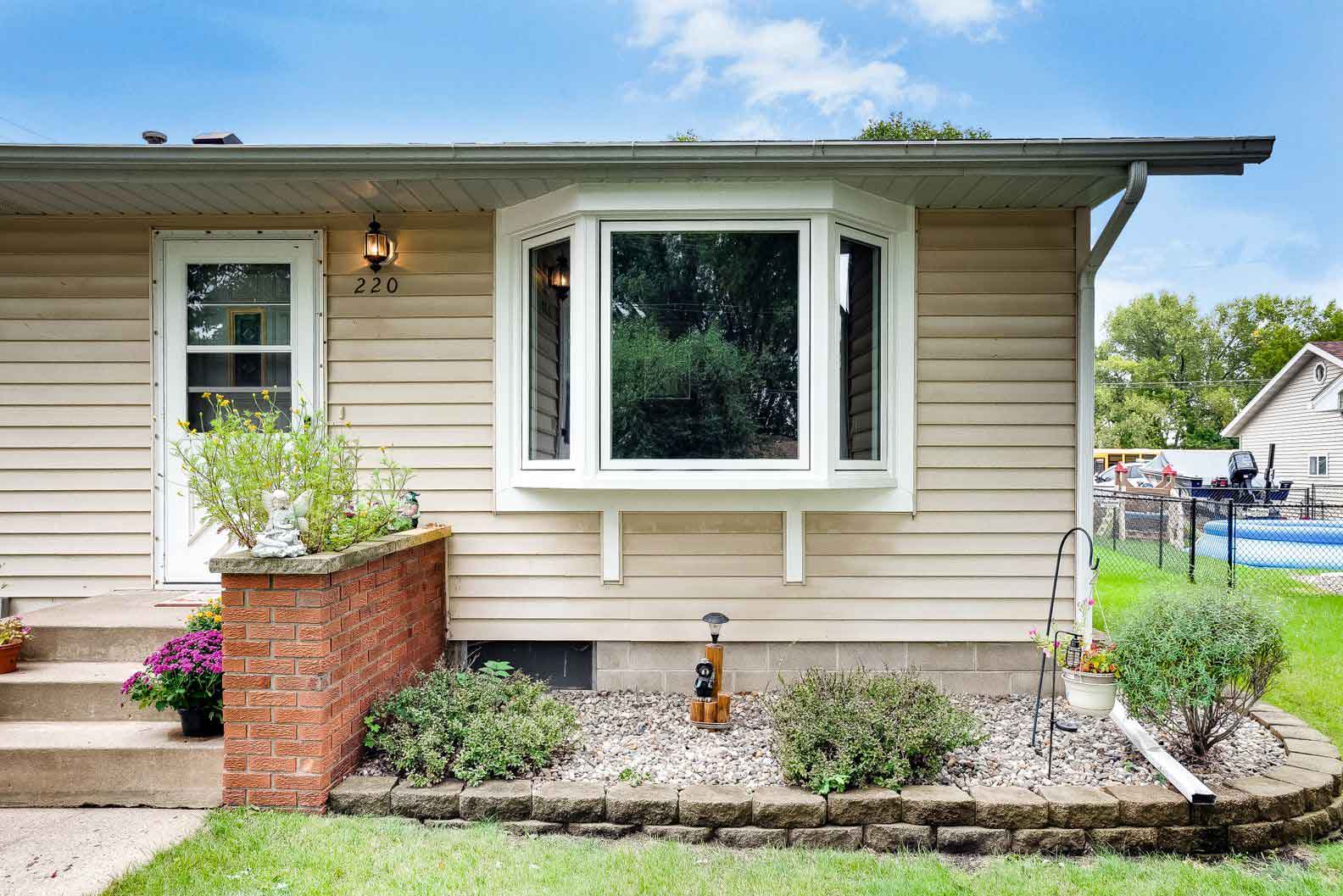 20240627_windows10 Beige siding home featuring new replacement bay window