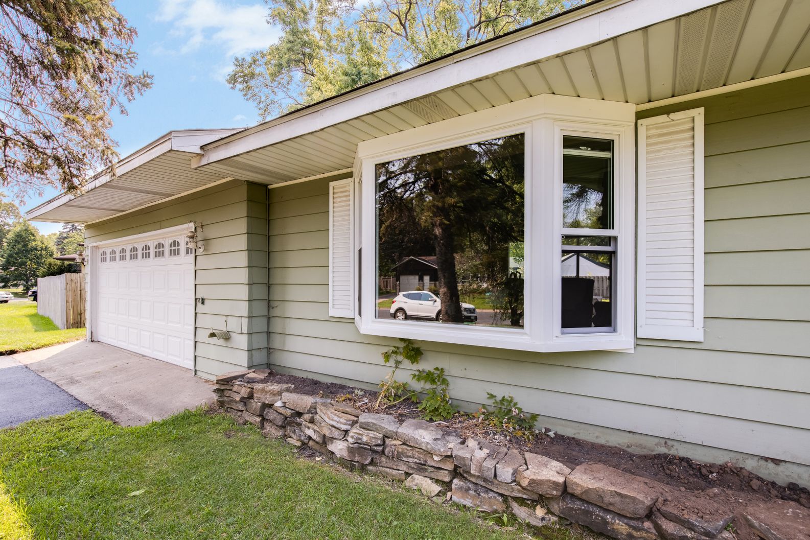 3221-Poe-Rd-AFTER_006 Green siding home featuring newly installed bay windows
