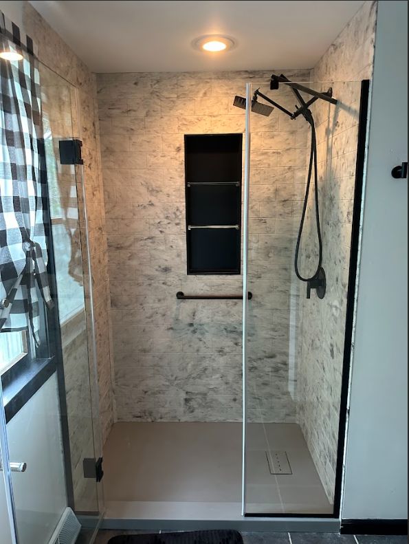 027cef8a79dd11efa2d15135f63121c5 Walk-in shower with rainfall showerhead and tiled wall niche