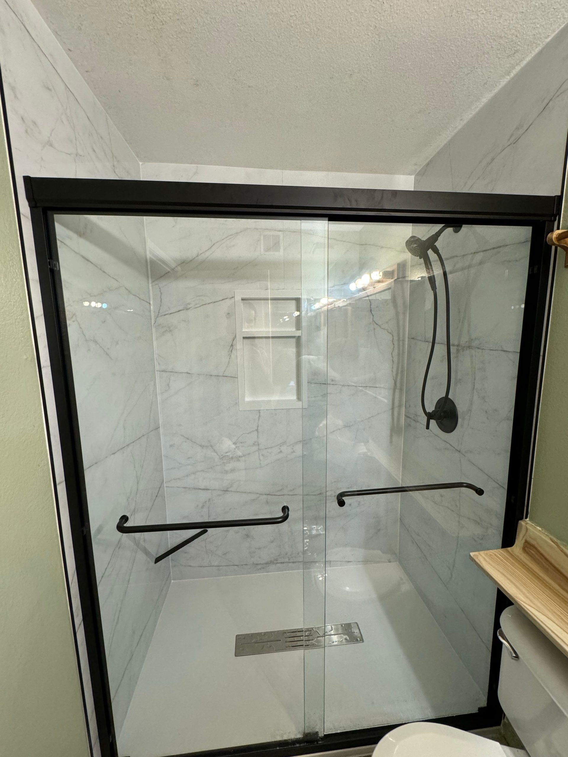 50c993e279d711efb721cf54145333ee Bathroom remodel with glass shower door and white tile walls