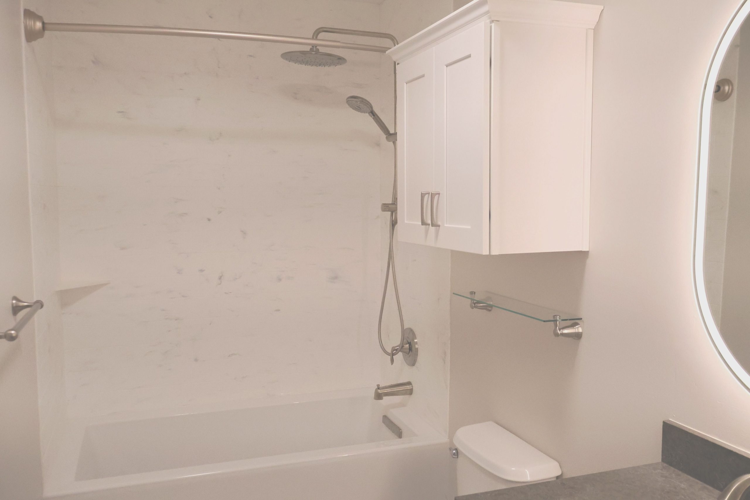 74c414ca208a11f08ae5cbb60e5b7d6a Bathroom remodel with bathtub, tile walls, and new fixtures