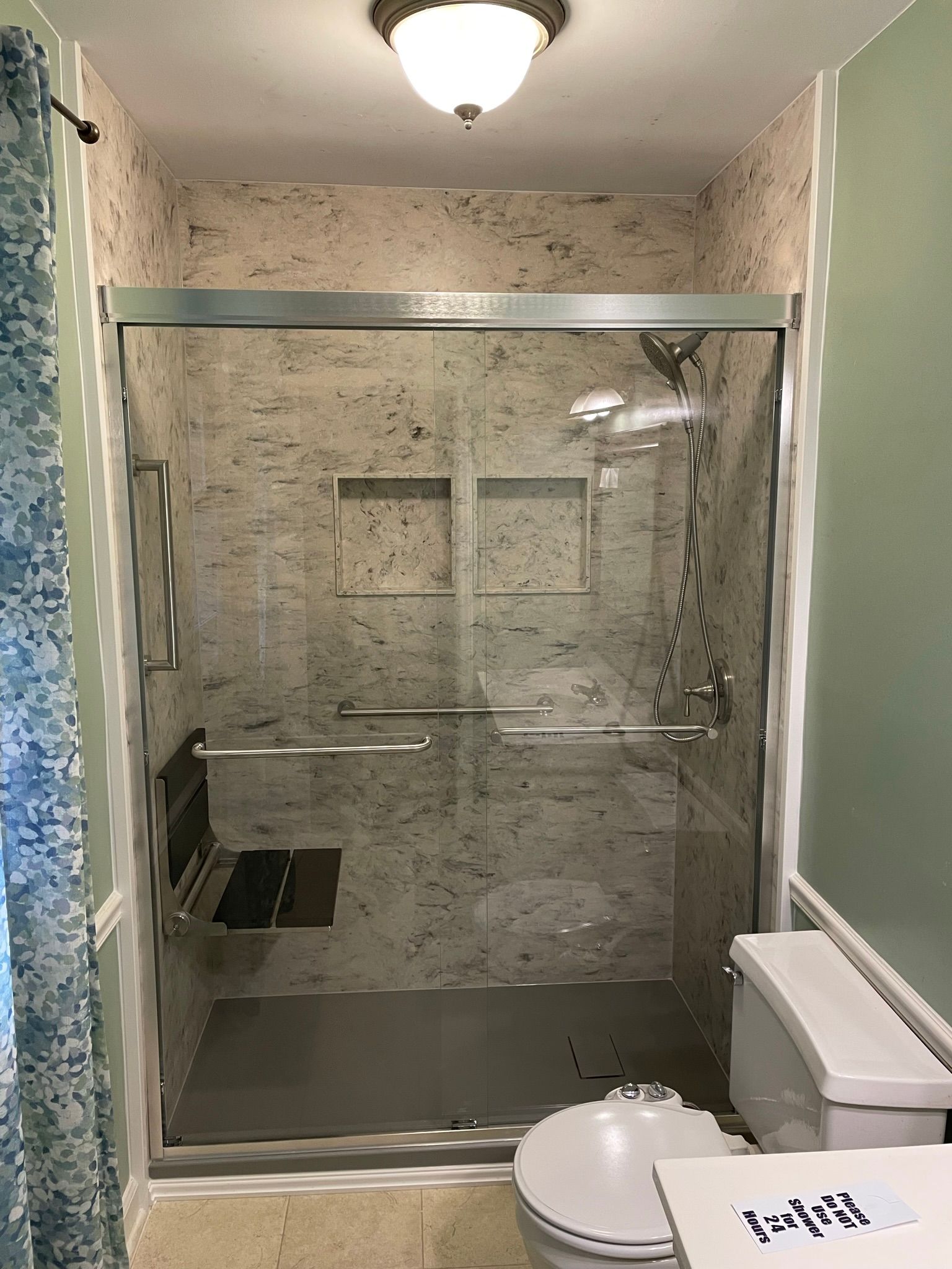 7618df5f208a11f0959431bf7cfa507e walk-in shower with built-in shelving and updated fixtures