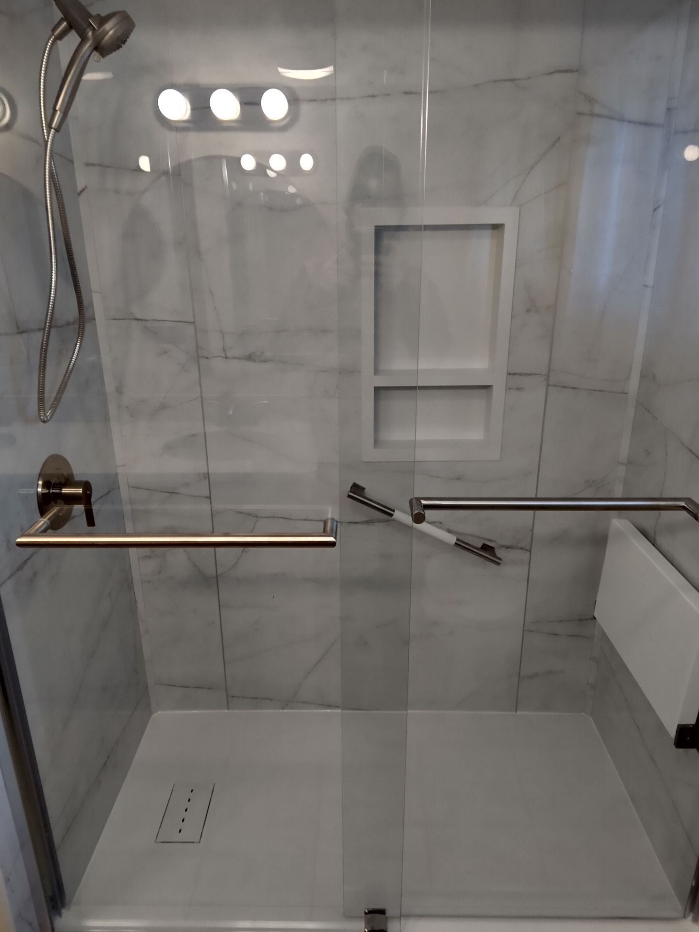 8266d4ea79d811efa2d15135f63121c5 Bathroom remodel with black framed glass shower and marble tile