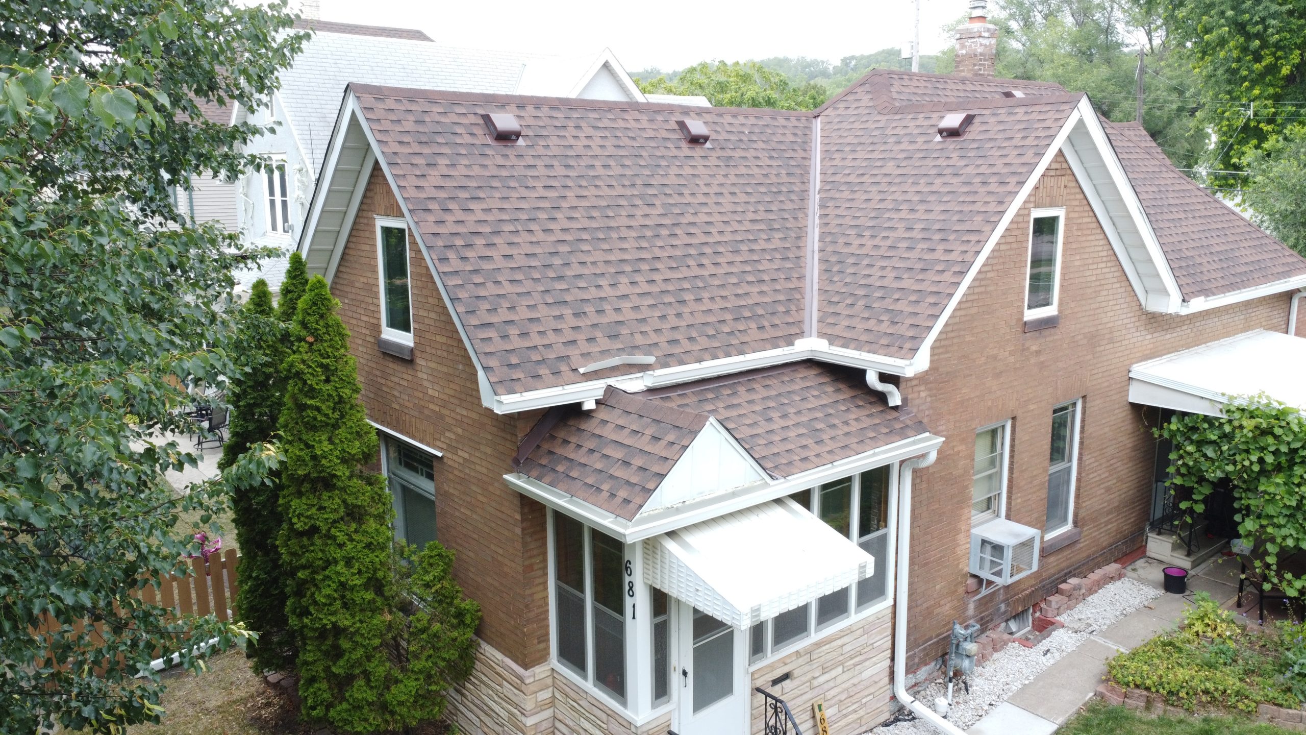 Aerial view of residential roof and new window installation