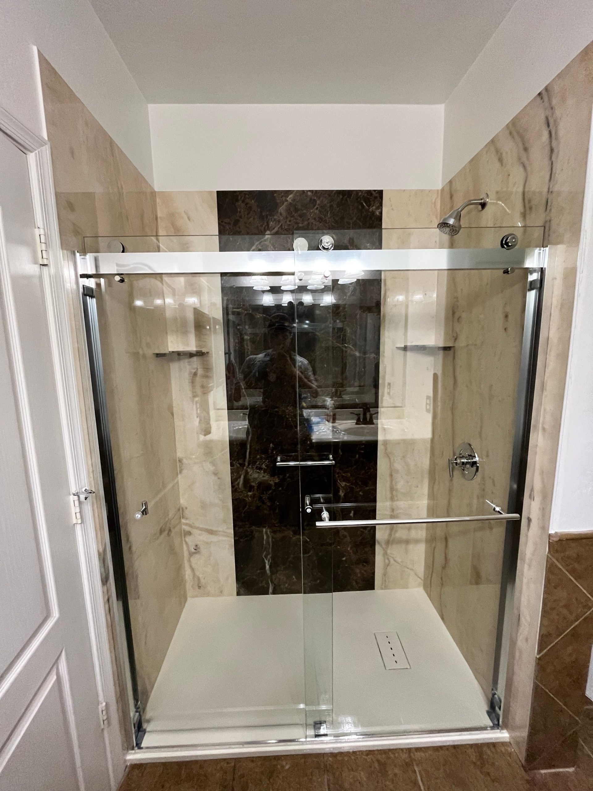 b62d2ae0210d11f0a2a959fe97d5d4f7 Glass shower enclosure with gray tile and stainless hardware